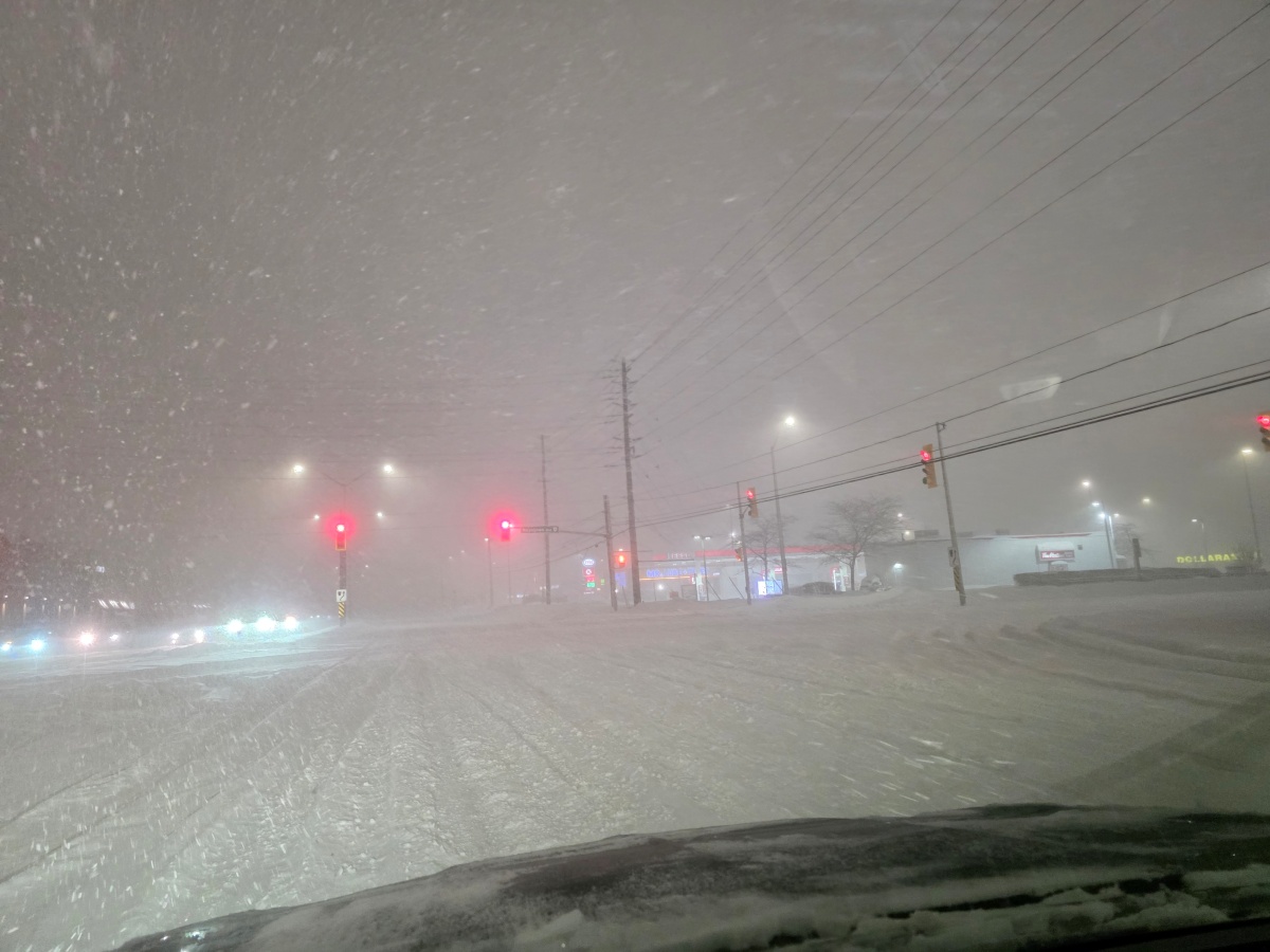 Snowy intersection with traffic lights during a severe winter storm
