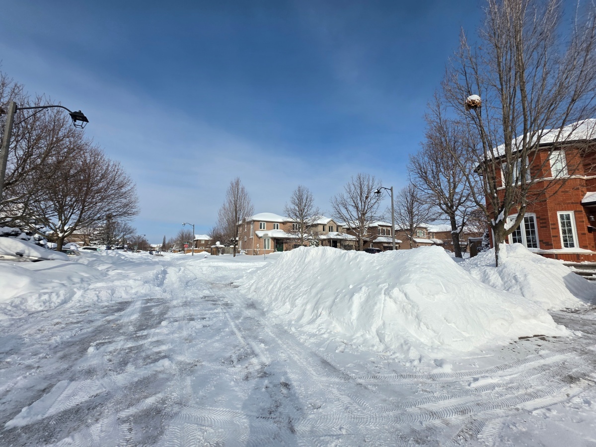 Snowbanks along a residential road after snow removal