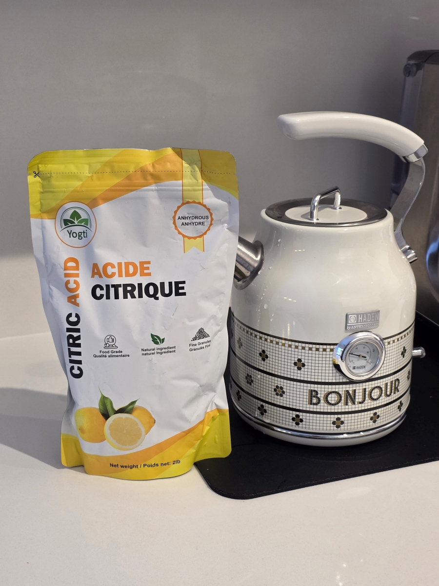 Food-grade citric acid next to an electric kettle