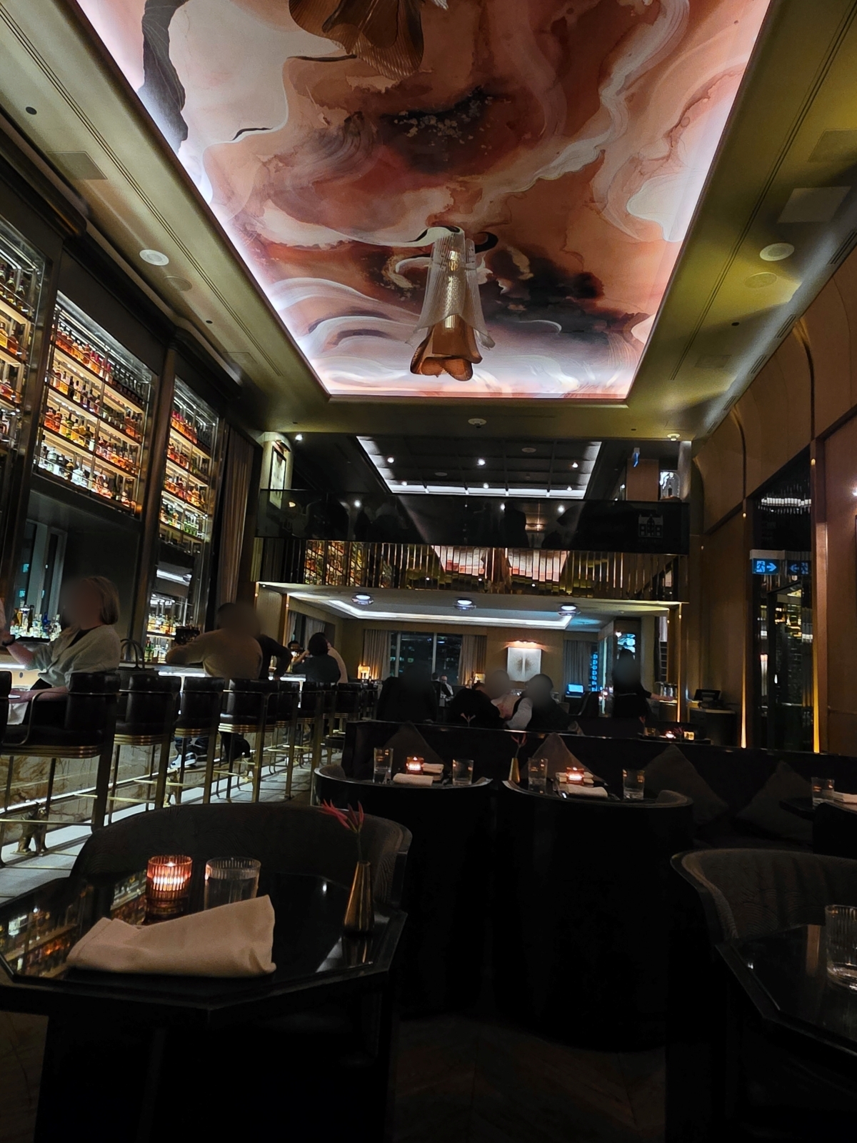 The swirling whiskey-inspired painted ceiling mural at the restaurant bar