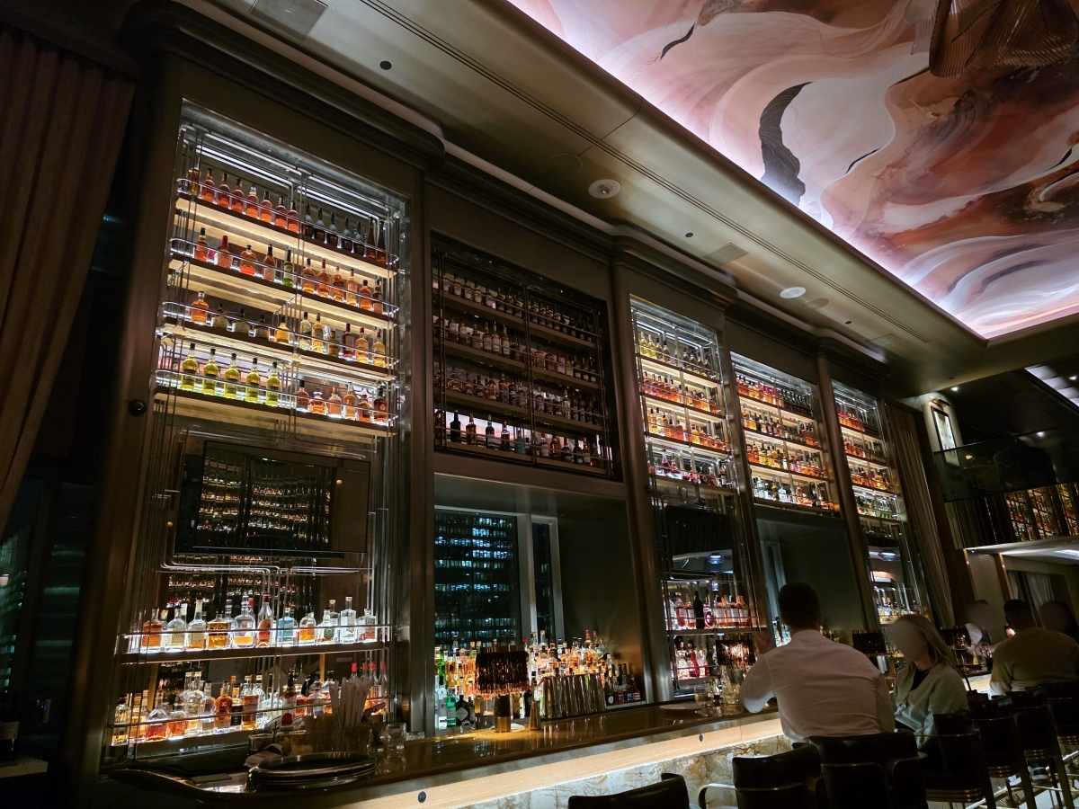The stunning two-story high liquor display and bar area at Louix Louis