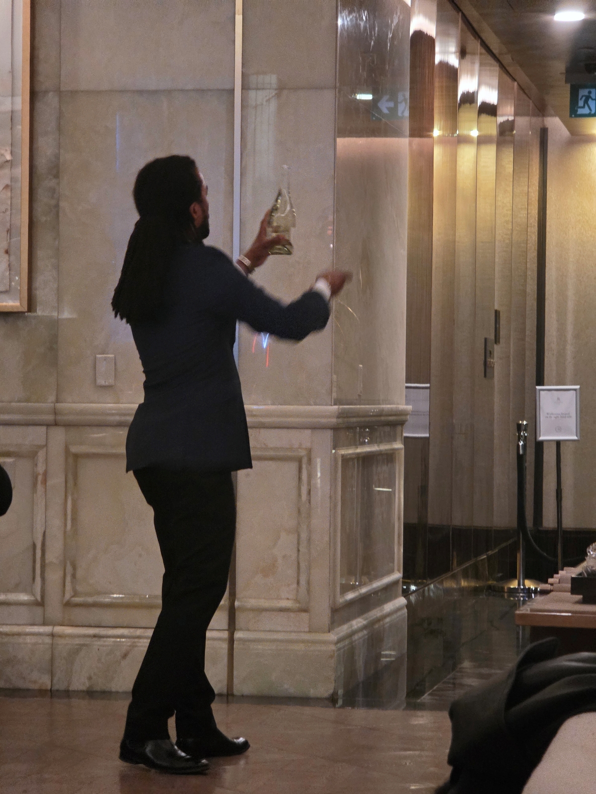 A St. Regis butler performing the evening champagne sabering ritual