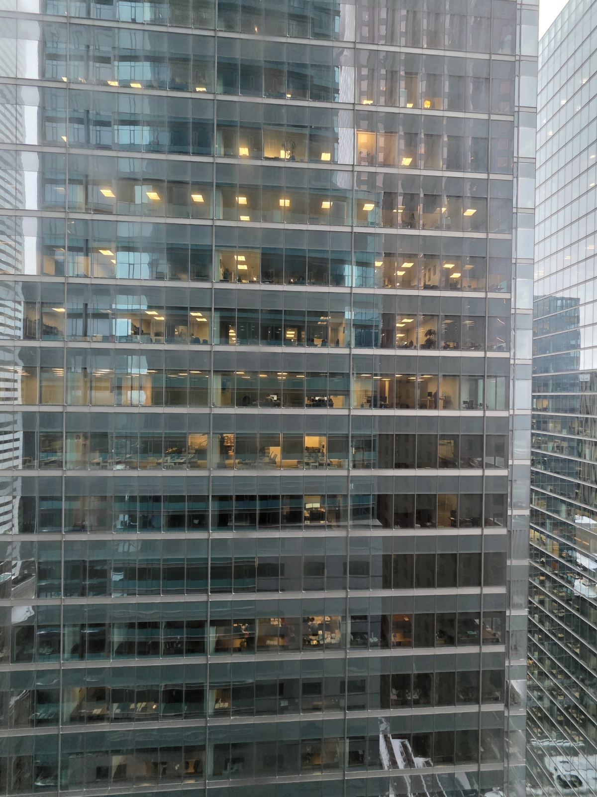 Looking out the hotel window directly at the glass facades of neighboring Toronto skyscrapers