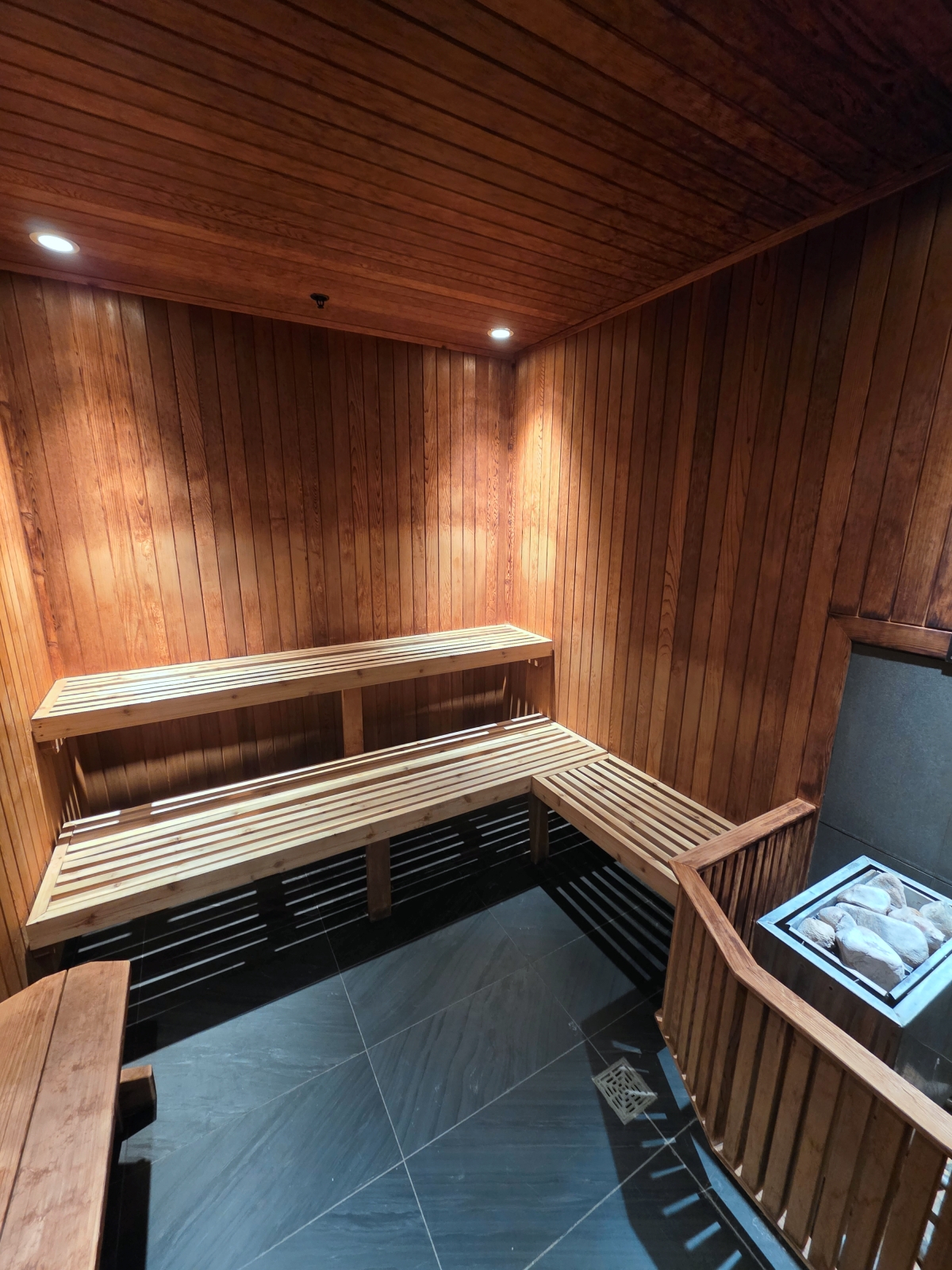 Interior of a wooden dry sauna with tiered seating at a hotel spa