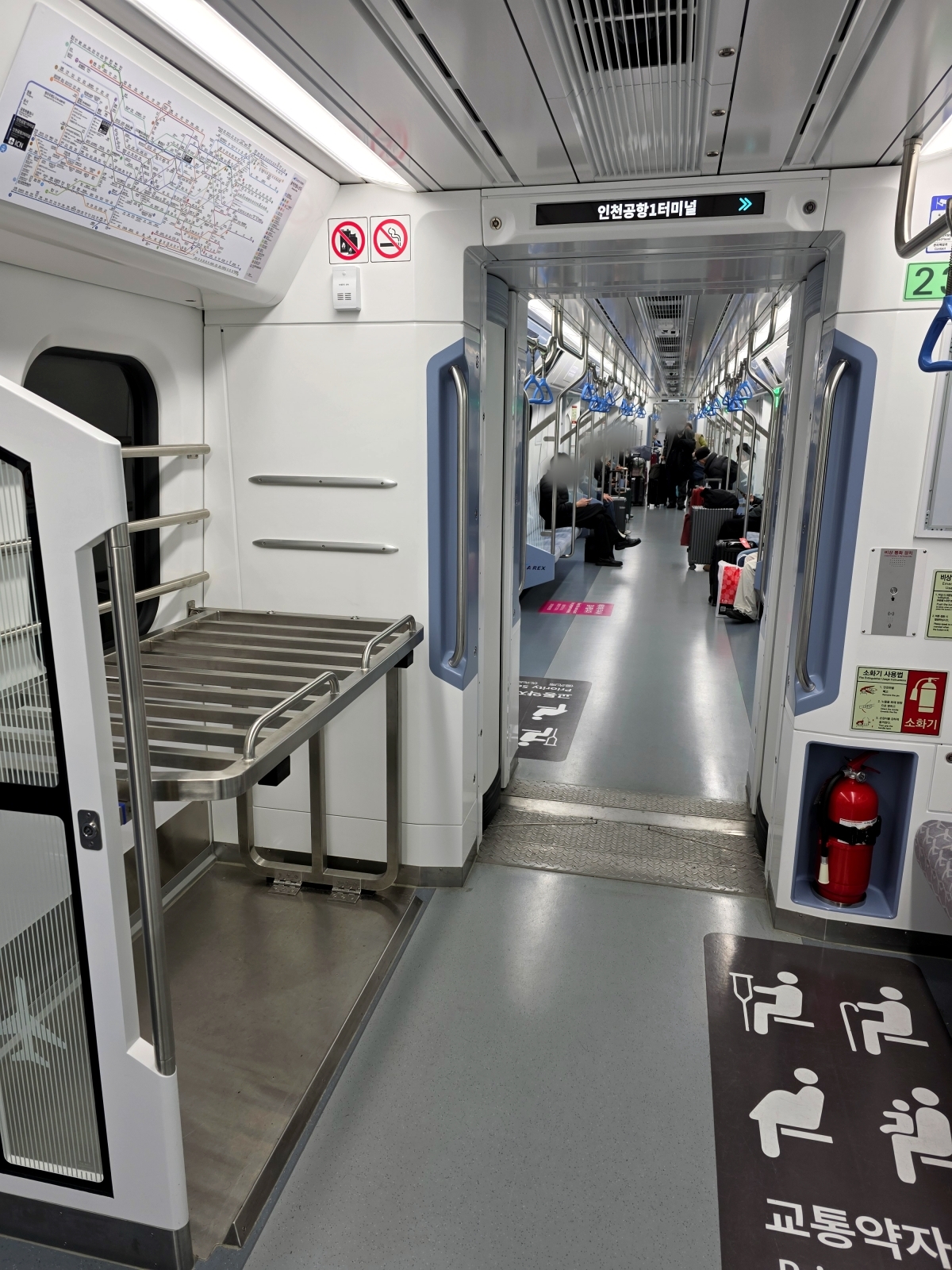 Empty metal luggage rack inside the AREX All-Stop Train car
