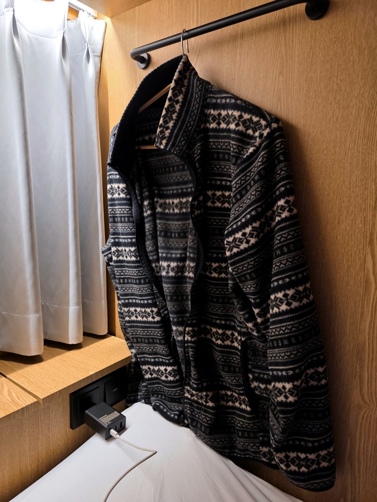 clothes hanger inside capsule bed