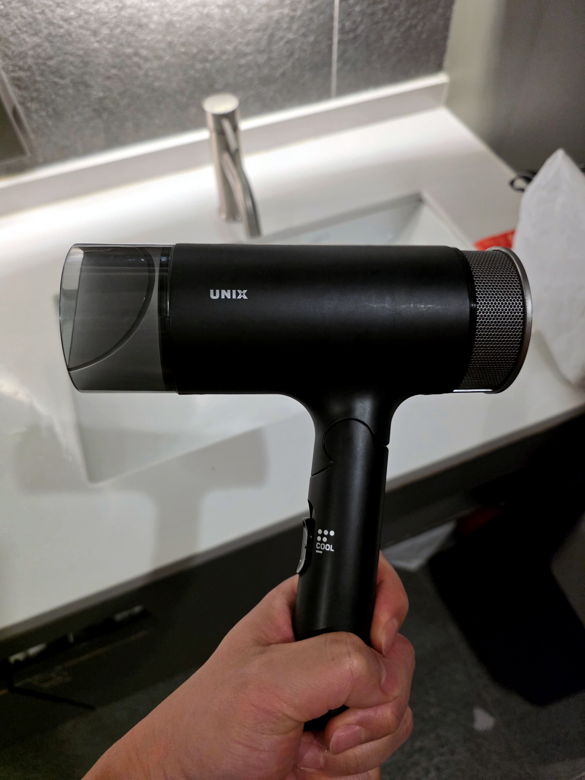 hair dryer stored under bathroom sink