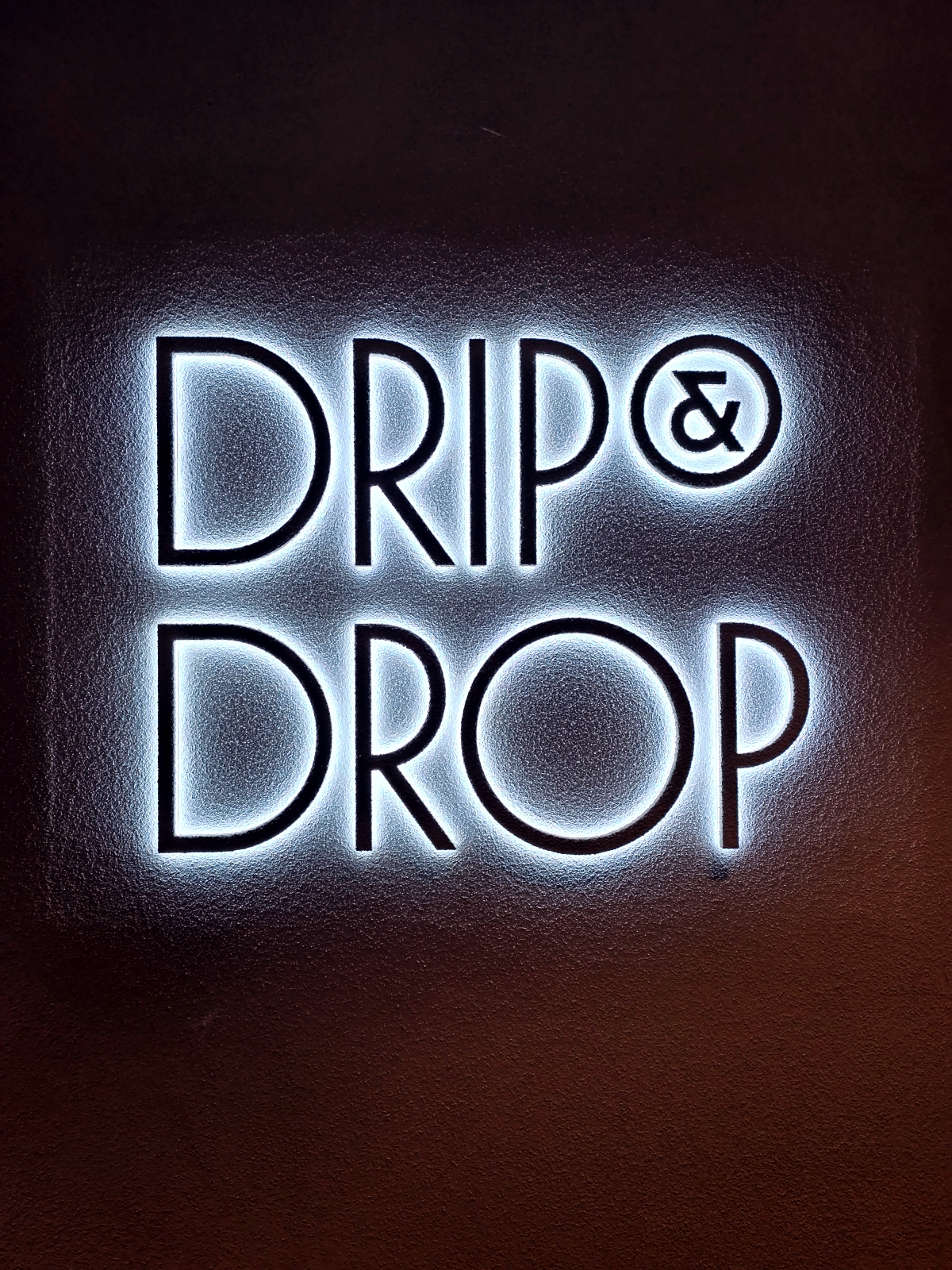 drip and drop neon sign inside hotel
