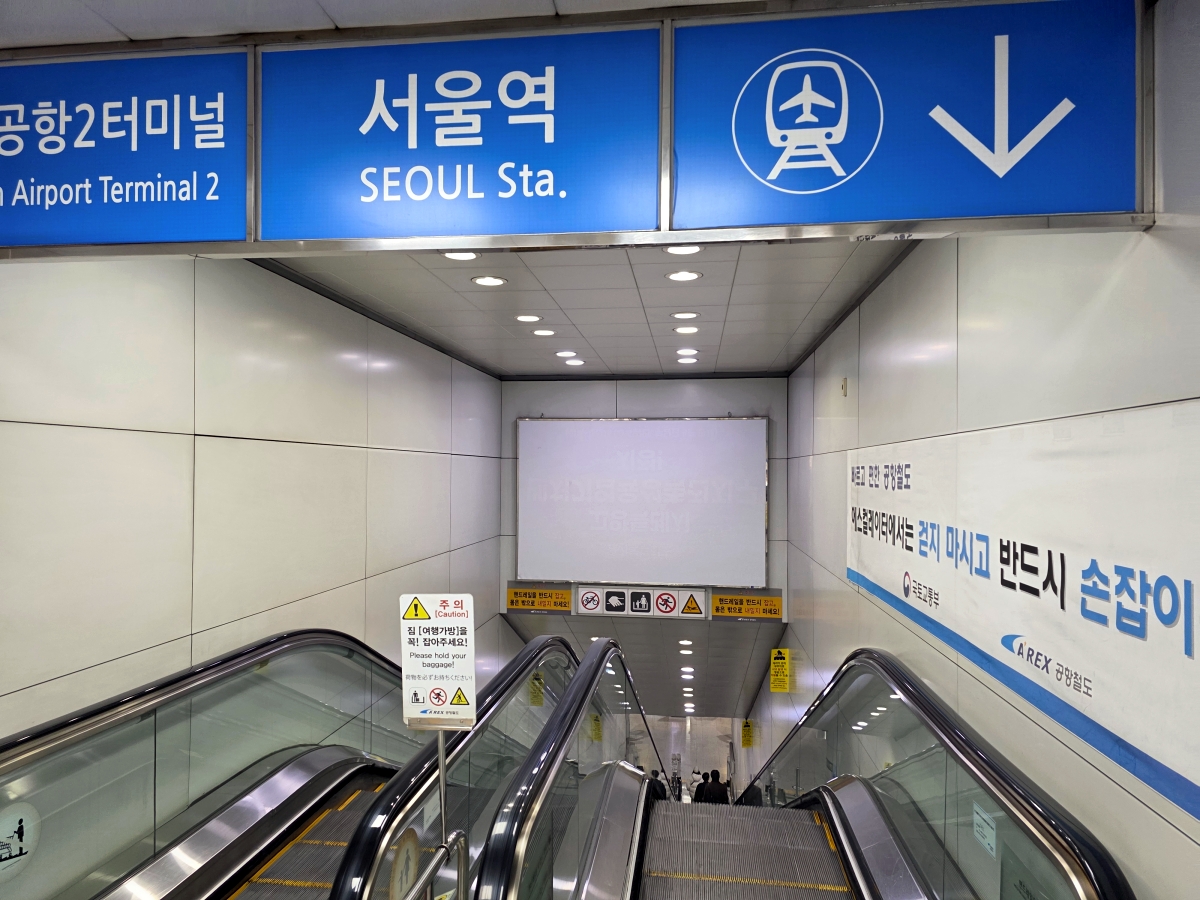 Long escalator leading down to the deep underground platform at Seoul Station