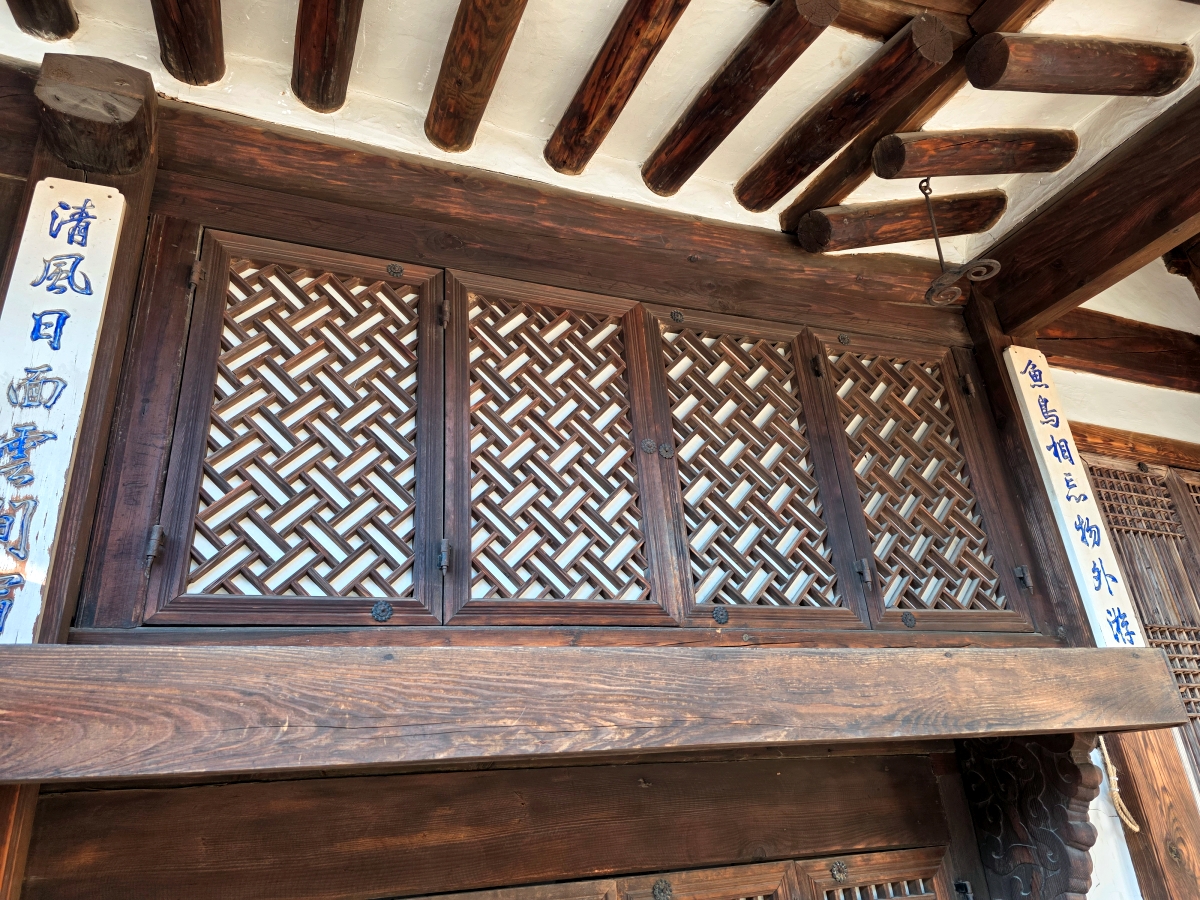 Intricate wooden lattice design on a Hanok window