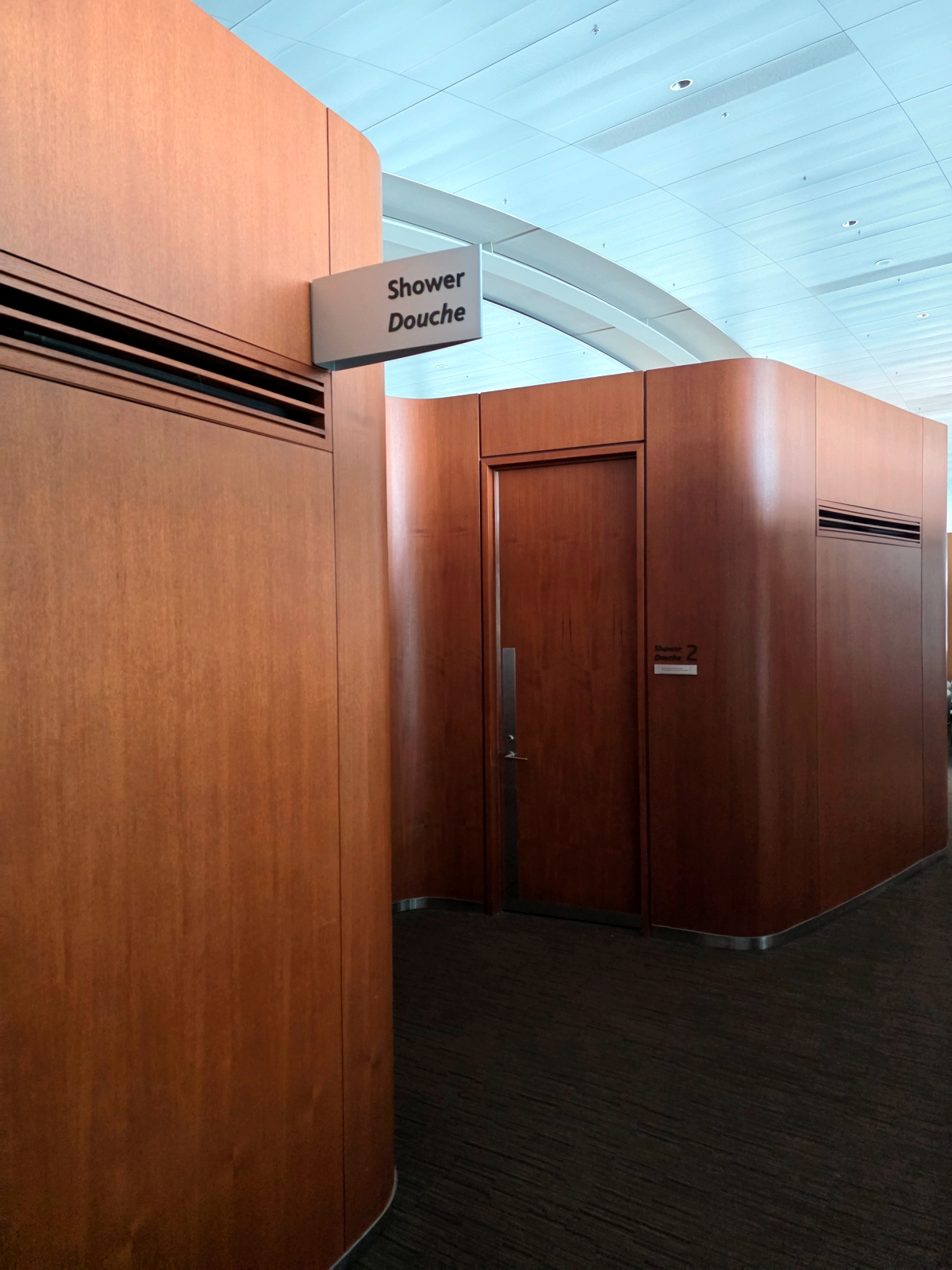 Corridor leading to the shower rooms inside the Maple Leaf Lounge at Toronto Airport