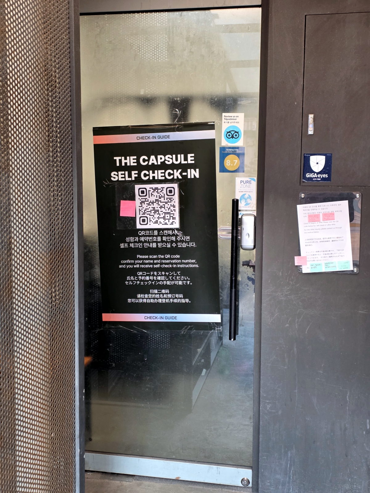 THE CAPSULE Myeongdong entrance door with check-in notice