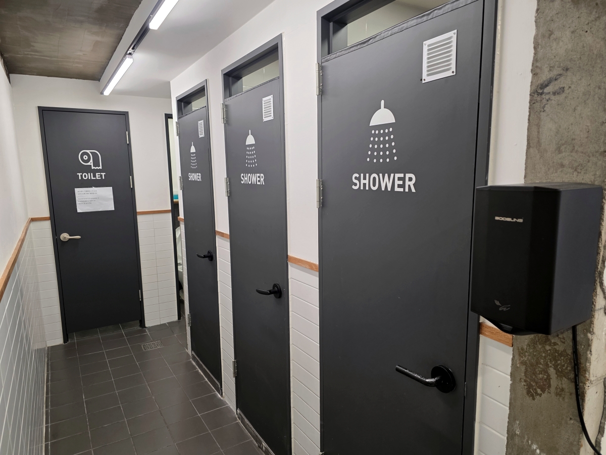 Shared shower and restroom area at The Cube Hotel Myeongdong