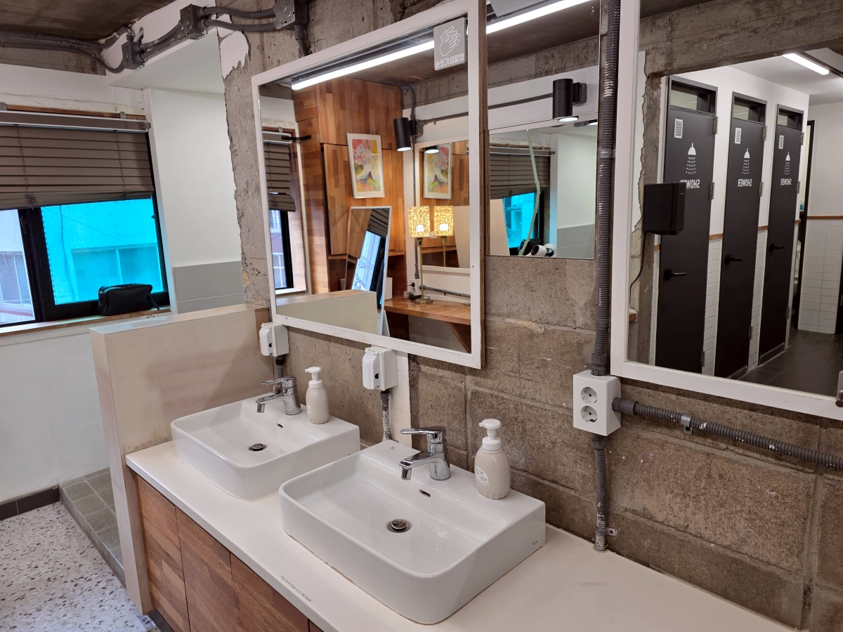 Sink area in shared shower and restroom at The Cube Hotel Myeongdong